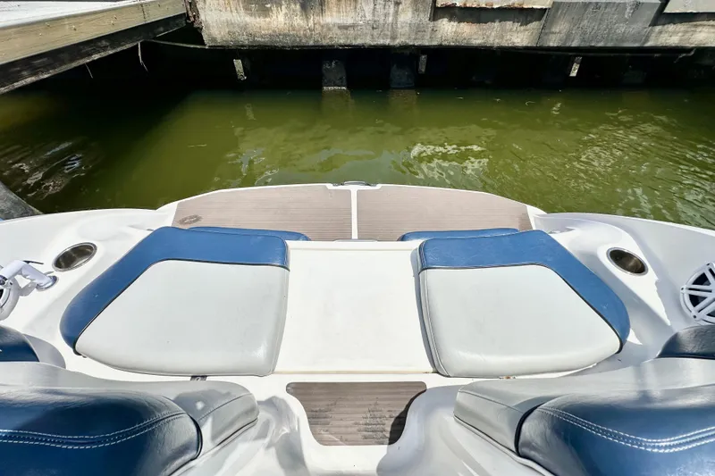 Slide: The Image of 2011 Yamaha Boats 242 Limited swim platform with cushioned seating by the water. - 20