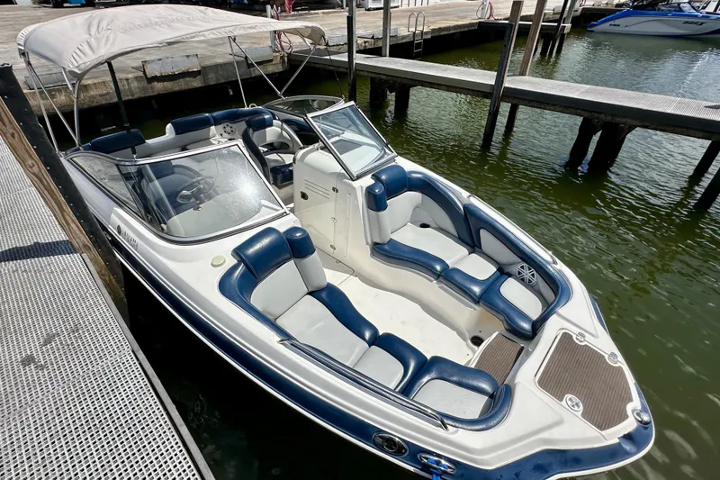 Slide: The Image of 2011 Yamaha Boats 242 Limited docked, featuring spacious seating and sleek design. - 25