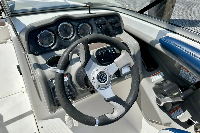 Slide: The Image of 2011 Yamaha Boats 242 Limited dashboard with steering wheel and control panel. - 8