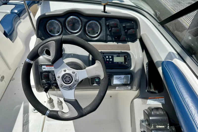 Slide: The Image of Steering wheel and dashboard of 2011 Yamaha Boats 242 Limited, featuring gauges and controls. - 9