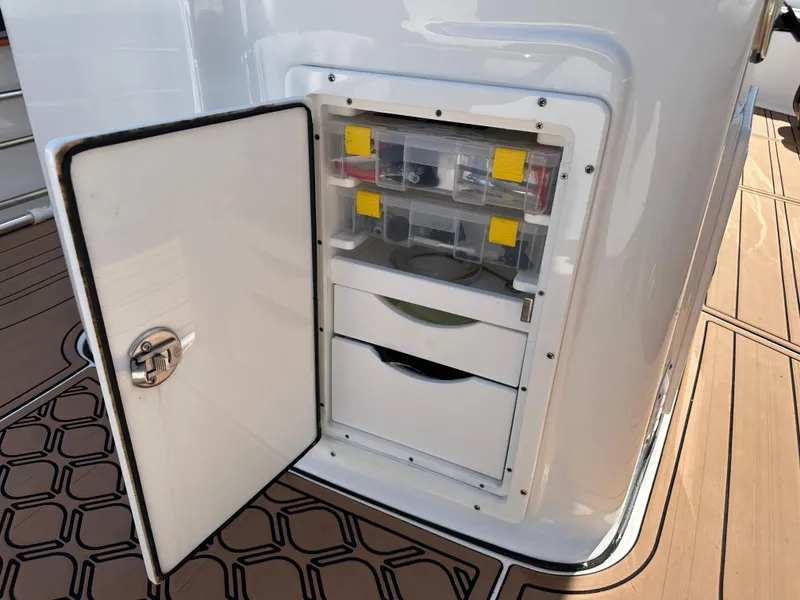 Slide: The Image of Open storage compartment on 2022 Tidewater 280 CC boat deck. - 13