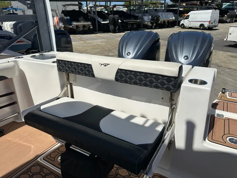 Slide: The Image of 2022 Tidewater 280 CC boat with dual engines and cushioned seating. - 15