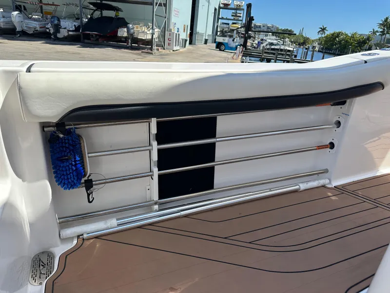 Slide: The Image of 2022 Tidewater 280 CC boat interior with rod holders and cleaning brush. - 16