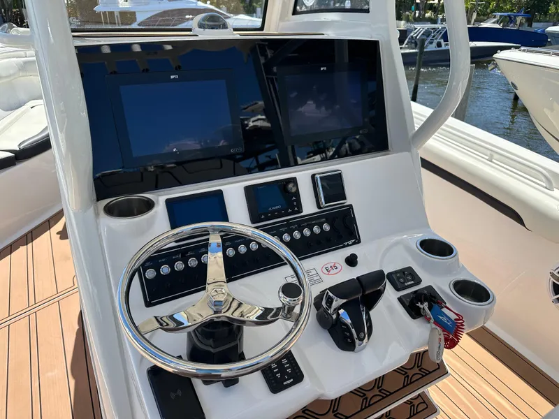Slide: The Image of 2022 Tidewater 280 CC boat dashboard with steering wheel and electronic displays. - 18