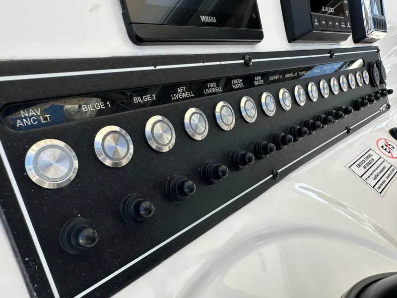 Slide: The Image of Control panel of 2022 Tidewater 280 CC boat with labeled switches and buttons. - 19