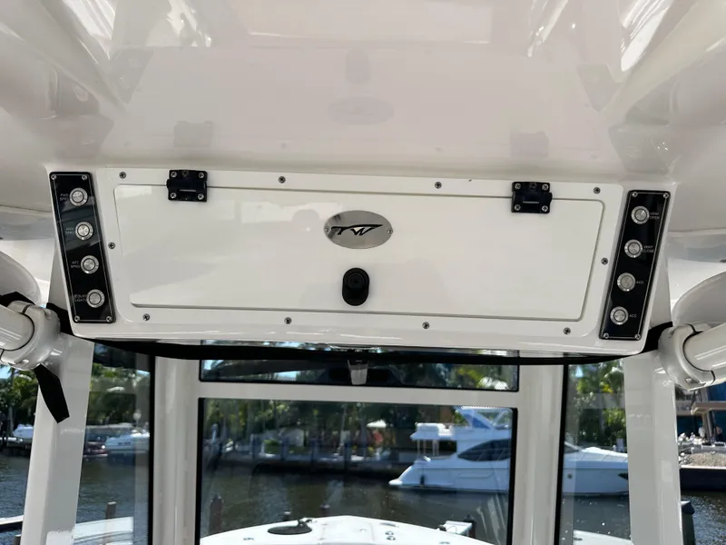 Slide: The Image of 2022 Tidewater 280 CC boat console with storage compartment and control panel. - 25