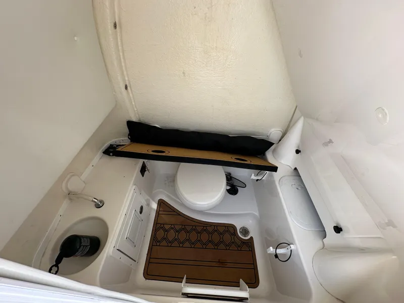Slide: The Image of 2022 Tidewater 280 CC boat interior bathroom with sink and toilet. - 30