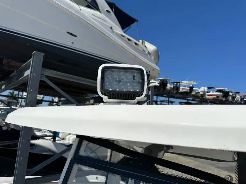 Slide: The Image of Tidewater 280 CC 2022 boat spotlight with docked vessels in background. - 37