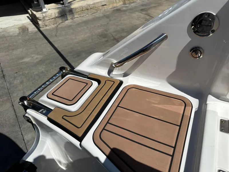 Slide: The Image of 2022 Tidewater 280 CC boat deck with non-slip surface and stainless steel handrail. - 8