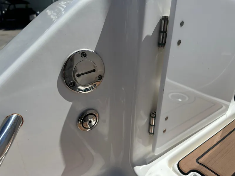 Slide: The Image of 2022 Tidewater 280 CC boat detail showing water inlet and hinge. - 9