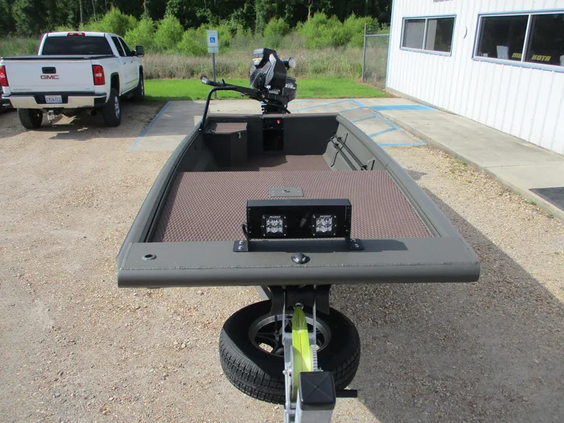 Slide: The Image of 2025 Gator Tail 1748 GATOR boat on trailer, parked outdoors near a building. - 2