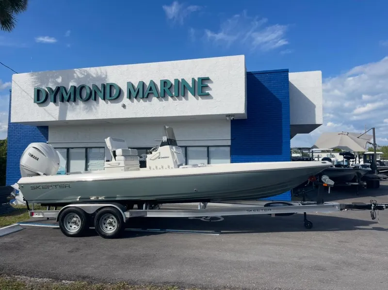 The Image of 2025 Skeeter SX230 boat on trailer outside Dymond Marine dealership. - 1