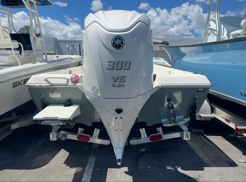 Slide: The Image of 2025 Skeeter SX230 boat with Yamaha 300 V6 engine, parked under a clear blue sky. - 3