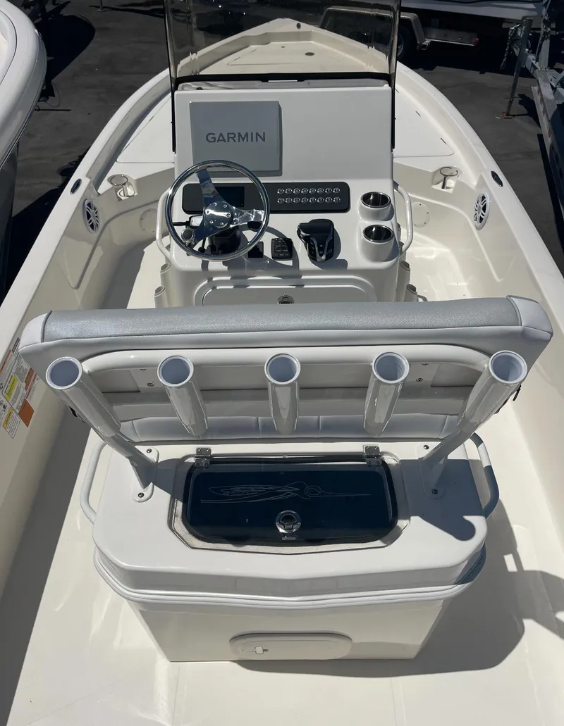 Slide: The Image of 2025 Skeeter SX230 boat interior with Garmin navigation system and rod holders. - 6