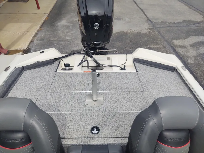 Slide: The Image of 2023 Tracker Pro Team 175 TXW boat interior with motor and seating. - 3