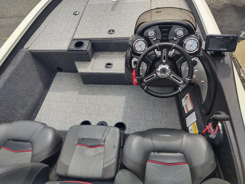 Slide: The Image of 2023 Tracker Pro Team 175 TXW boat interior with steering console and seating. - 4