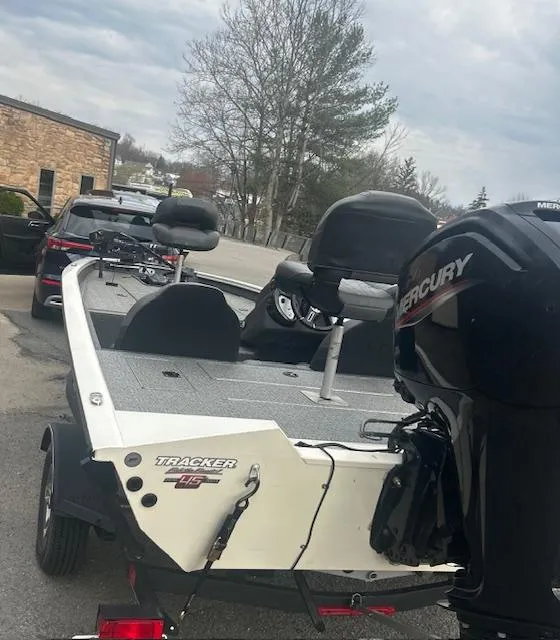 Slide: The Image of 2023 Tracker Pro Team 175 TXW boat with Mercury engine, parked outdoors. - 6