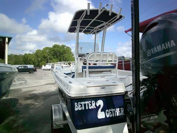 Slide: The Image of 2023 Robalo 206 Cayman boat on trailer, featuring Yamaha engine, in a sunny marina. - 5