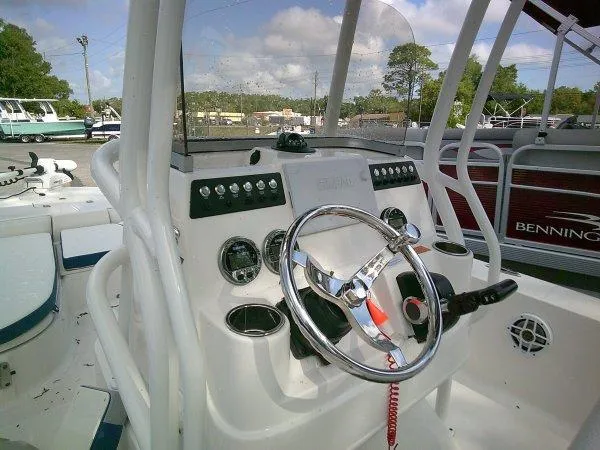 Slide: The Image of 2023 Robalo 206 Cayman boat dashboard with steering wheel and control panel. - 8