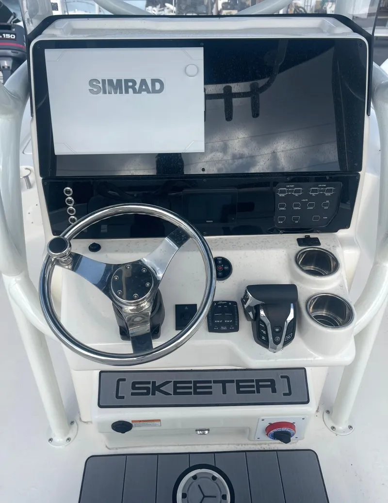 Slide: The Image of 2025 Skeeter SX 2350 boat console with Simrad display and steering wheel. - 11