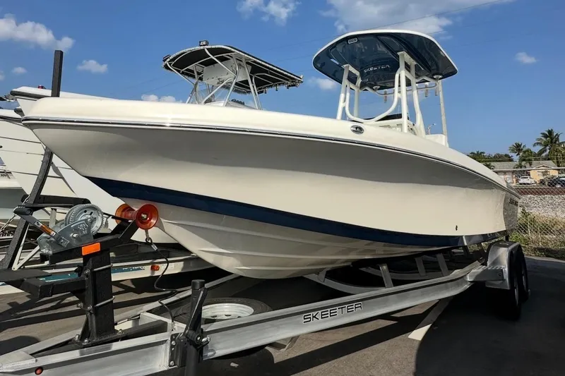 Slide: The Image of 2025 Skeeter SX 2350 boat on trailer under clear blue sky. - 12