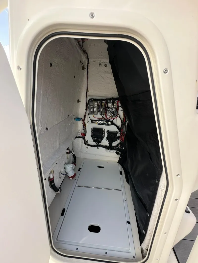 Slide: The Image of 2025 Skeeter SX 2350 boat storage compartment with electrical components and wiring. - 7