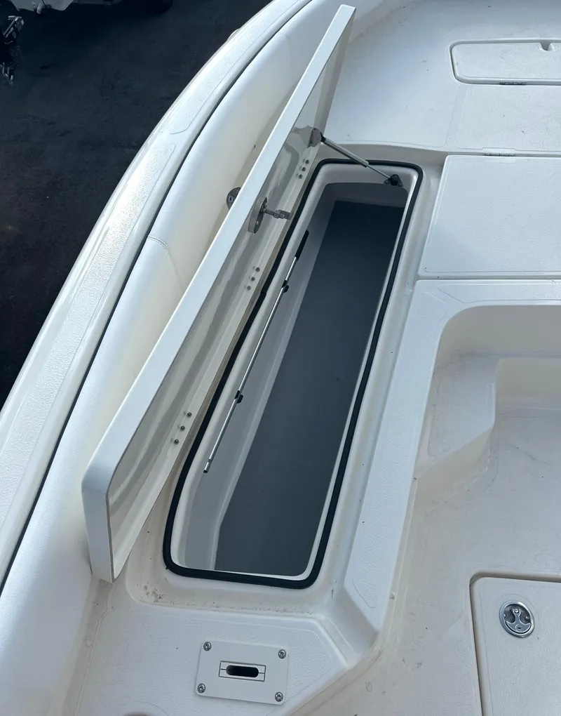 Slide: The Image of 2025 Skeeter SX 2350 boat storage compartment with open lid, showcasing interior space. - 8