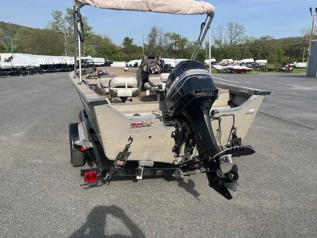 Slide: The Image of 2001 Tracker Pro Deep V 17 SC boat with outboard motor, parked on a trailer. - 5