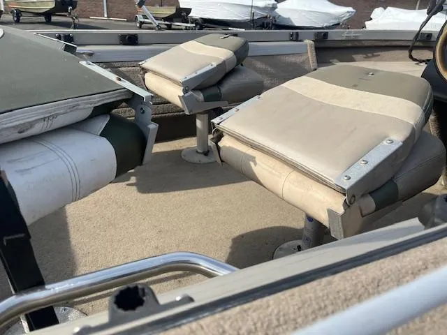 Slide: The Image of 2001 Tracker Pro Deep V 17 SC boat seats, beige and green, close-up view. - 8