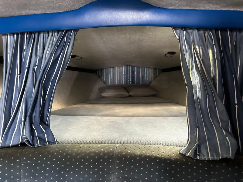 Slide: The Image of Interior cabin of 1987 Formula 357 SR1 with striped curtains and cozy bedding. - 8