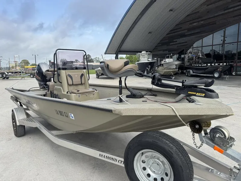 Slide: The Image of 2019 Alumacraft 18 Bay boat on trailer, parked outside a dealership. - 12