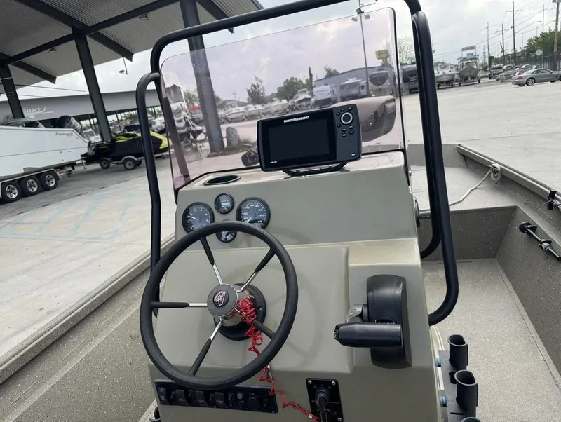 Slide: The Image of 2019 Alumacraft 18 Bay boat dashboard with steering wheel and navigation system. - 15
