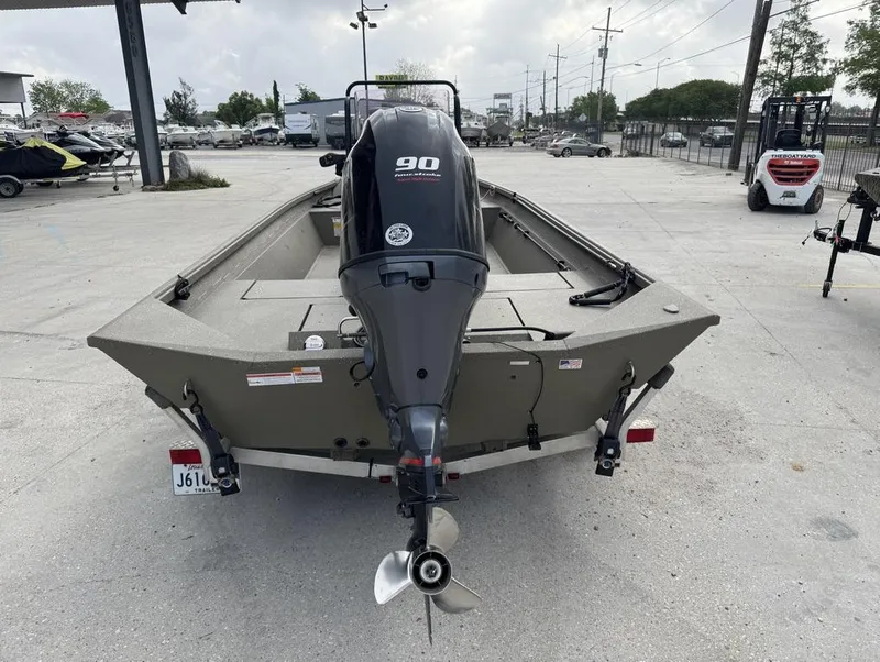 Slide: The Image of 2019 Alumacraft 18 Bay boat with 90 HP engine, parked outdoors. - 8