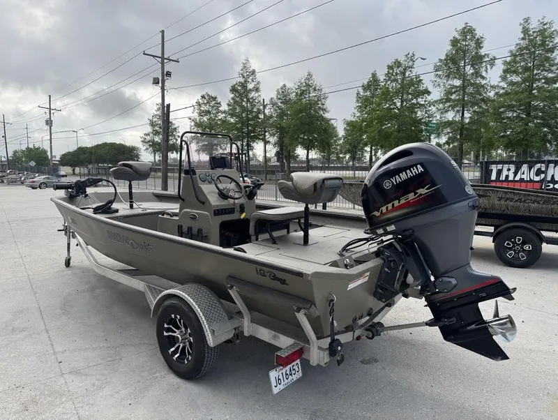Slide: The Image of 2019 Alumacraft 18 Bay boat with Yamaha engine, parked outdoors on a trailer. - 9