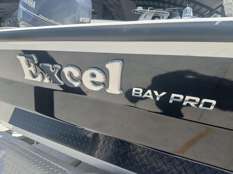 Slide: The Image of Excel Bay Pro 220 boat, 2022 model, with Yamaha engine in background. - 2