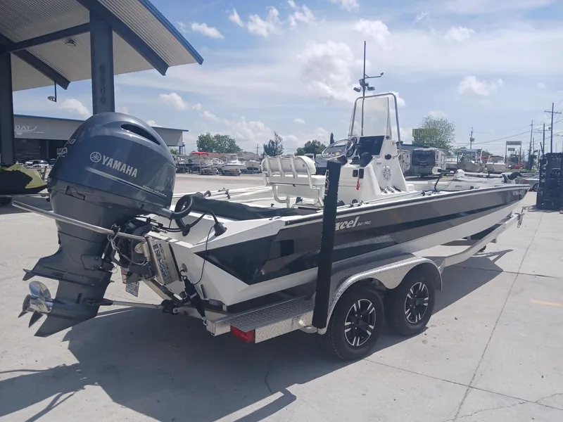 Slide: The Image of 2022 Excel 220 boat with Yamaha outboard motor on a trailer, parked outdoors. - 3