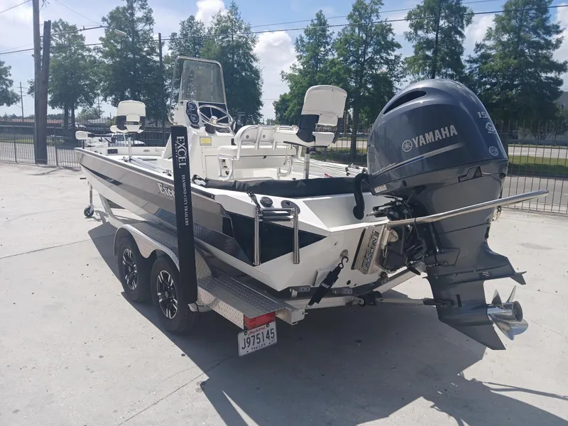 Slide: The Image of 2022 Excel 220 boat with Yamaha engine on trailer, parked outdoors. - 8