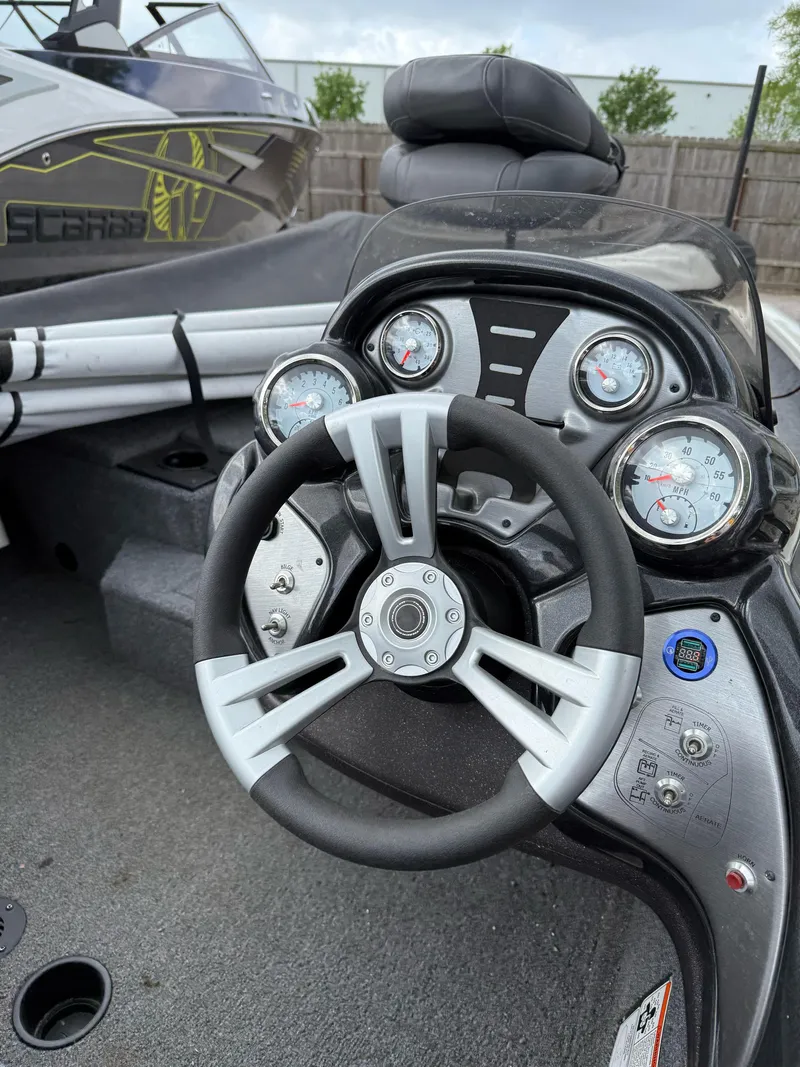 Slide: The Image of 2023 Tracker Pro Team 175 TXW boat dashboard with steering wheel and gauges. - 3