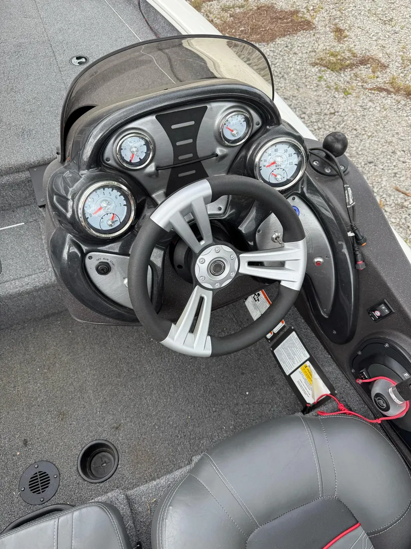 Slide: The Image of 2023 Tracker Pro Team 175 TXW boat dashboard with steering wheel and gauges. - 4