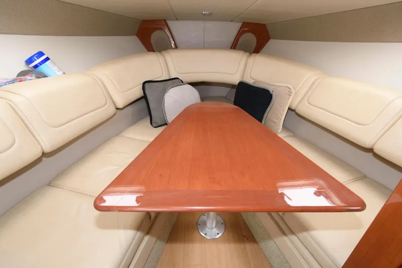 Slide: The Image of Interior cabin of 2012 Formula 290 Sun Sport with beige seating and wooden table. - 14