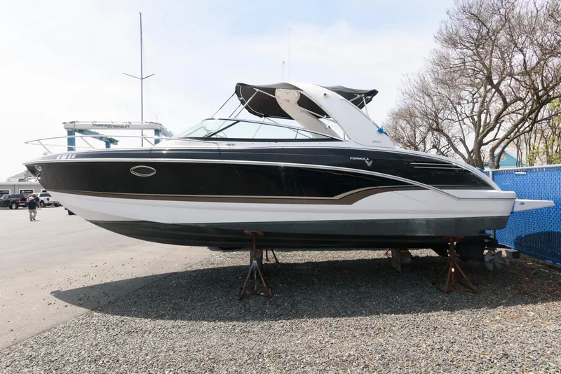 Slide: The Image of 2012 Formula 290 Sun Sport boat on dry dock, black and white exterior. - 2