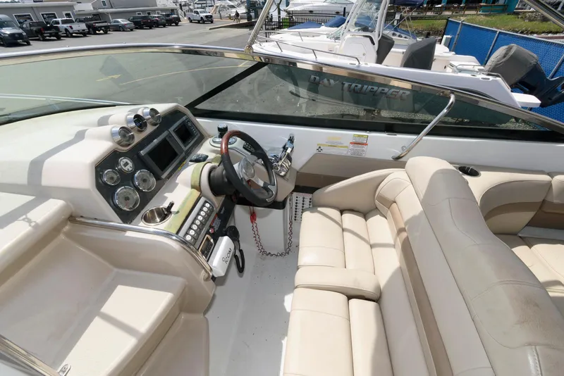 Slide: The Image of 2012 Formula 290 Sun Sport boat interior with beige seating and modern dashboard. - 6