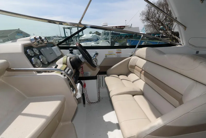 Slide: The Image of 2012 Formula 290 Sun Sport boat interior with beige seating and control panel. - 7