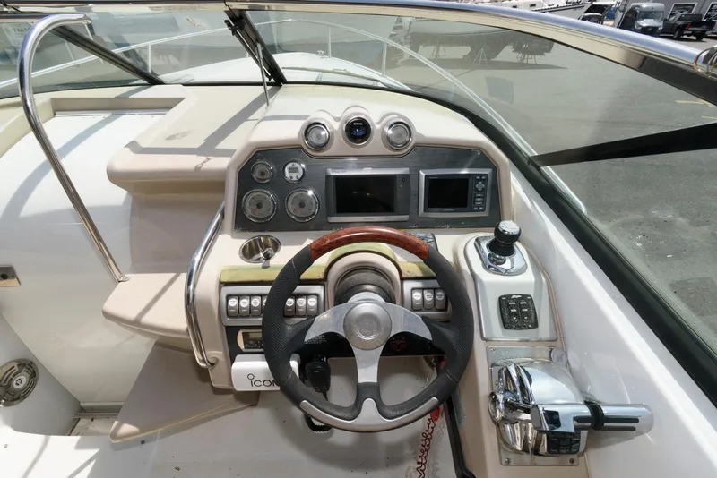 Slide: The Image of 2012 Formula 290 Sun Sport boat dashboard with steering wheel and control panel. - 8