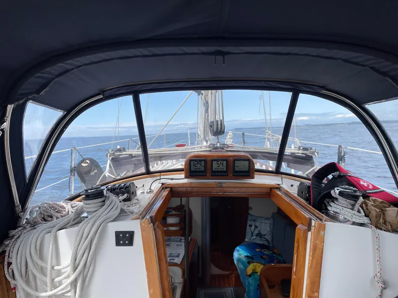 Slide: The Image of Interior view of 1984 Ohlson 38 sailboat cockpit with ocean in background. - 15