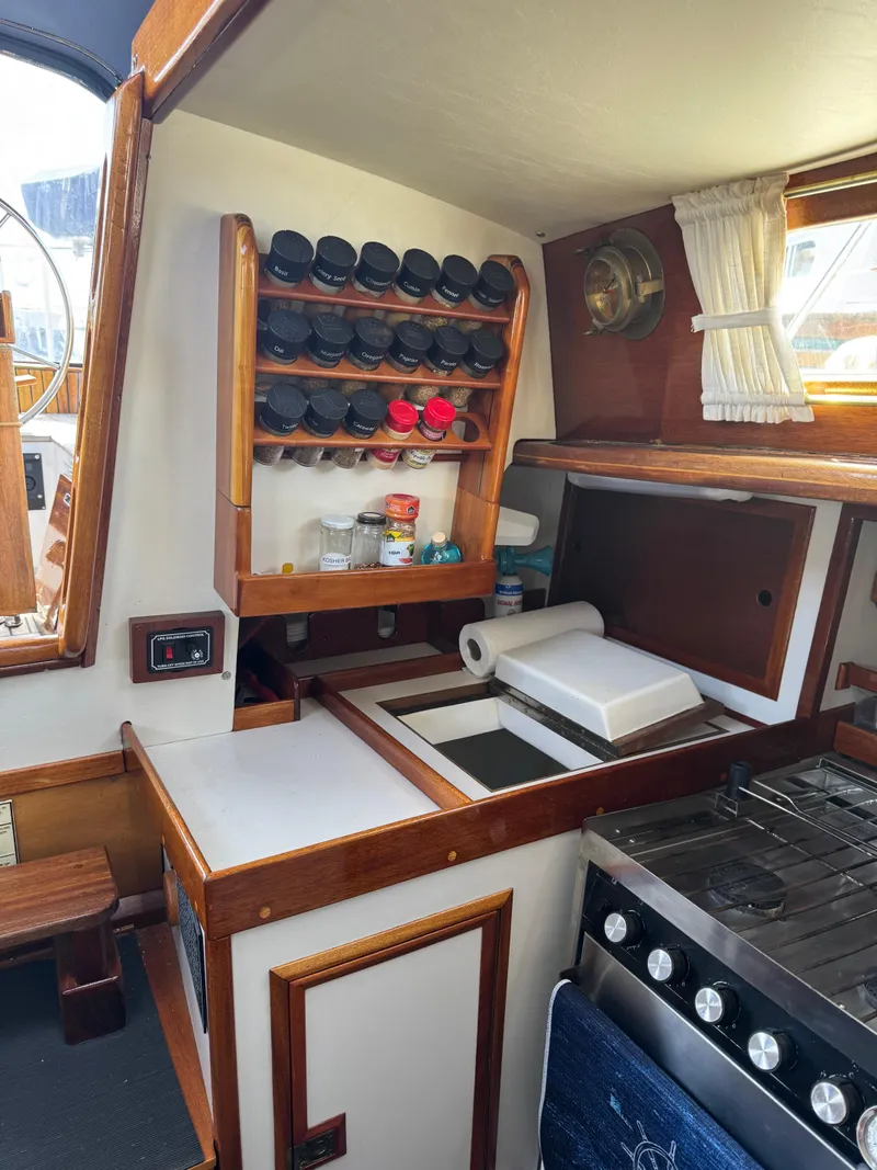 Slide: The Image of 1984 Ohlson 38 yacht kitchen with spice rack, stove, and storage. - 24