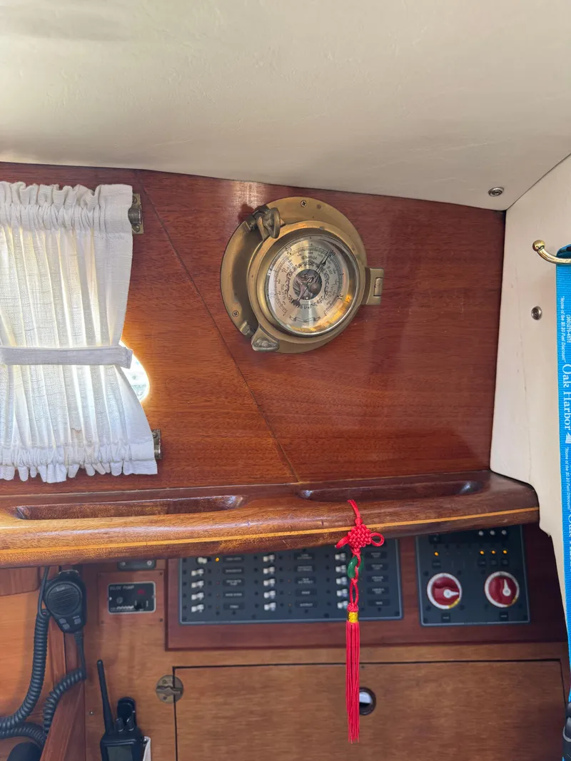 Slide: The Image of Interior of 1984 Ohlson 38 sailboat with porthole, curtain, and control panel. - 25