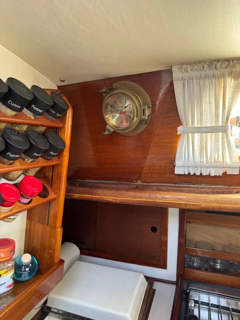 Slide: The Image of Interior of 1984 Ohlson 38 sailboat with spice rack and nautical clock. - 26