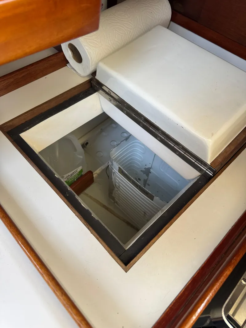 Slide: The Image of Open storage compartment on 1984 Ohlson 38 boat with paper towel roll. - 27