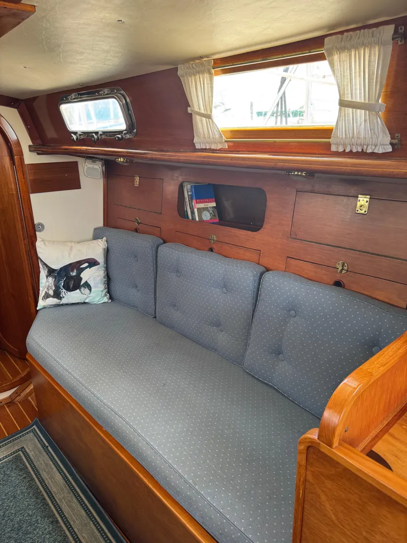 Slide: The Image of Interior of 1984 Ohlson 38 sailboat with cozy seating and wooden cabinetry. - 29